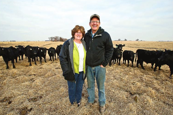 Luke and Lori Jacobsen in pasture with cattle